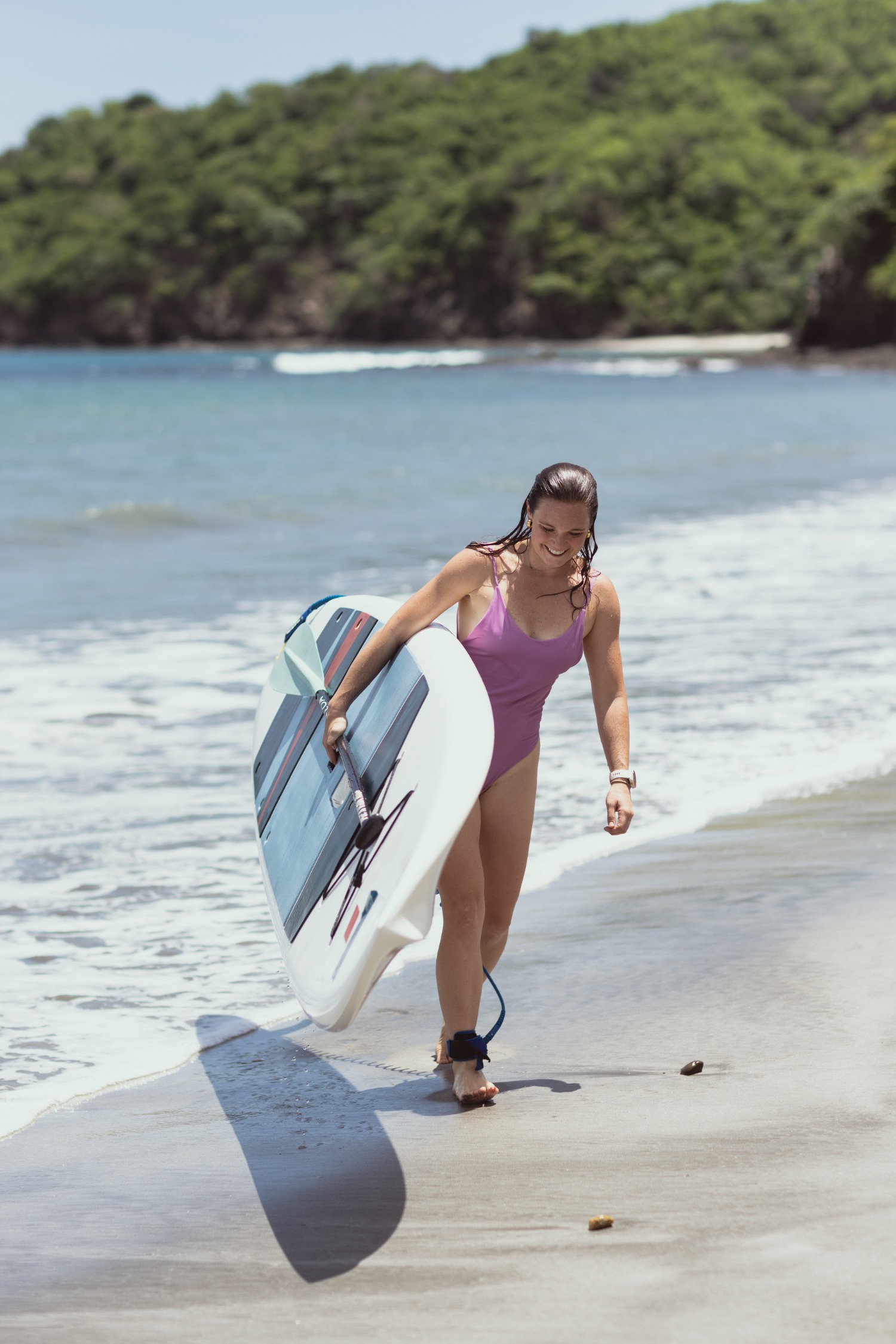 a woman holding a surf board