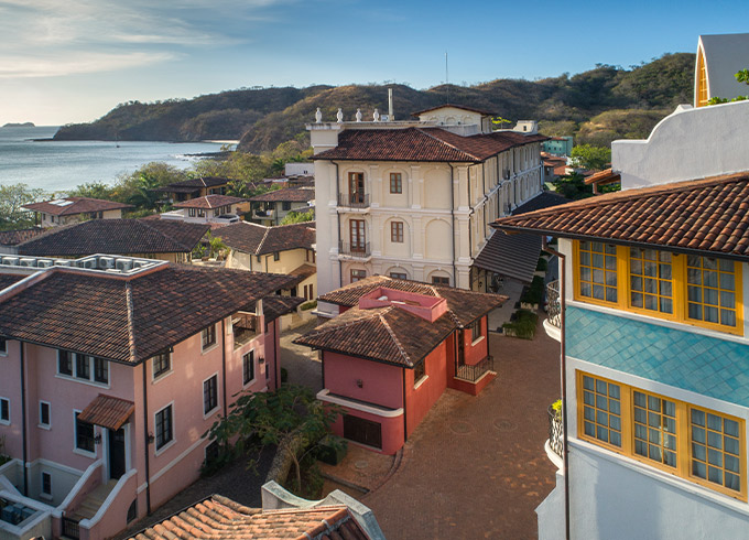a colorful group of buildings overlooking the ocean