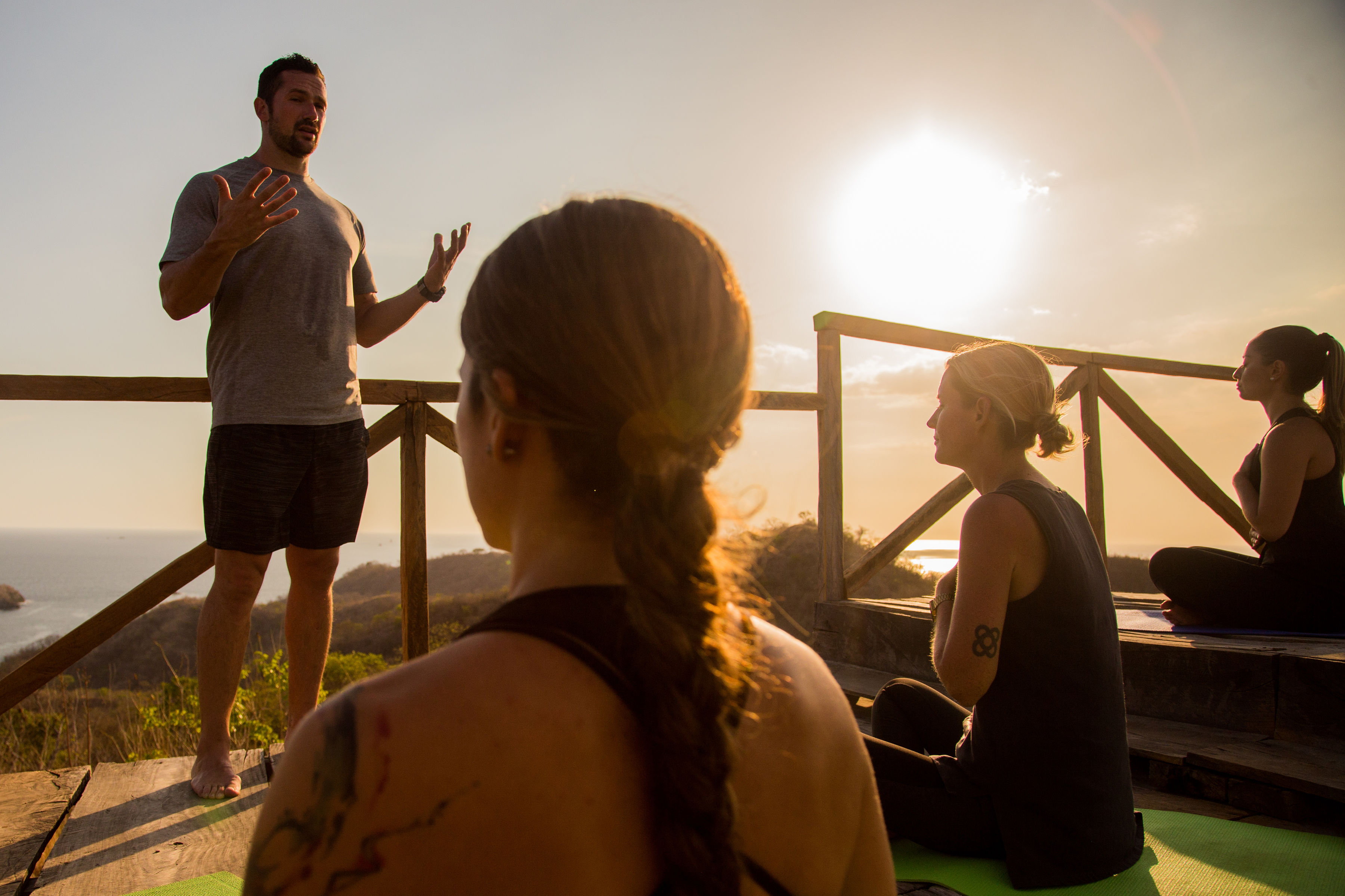 an instructor teaching breath work at dusk