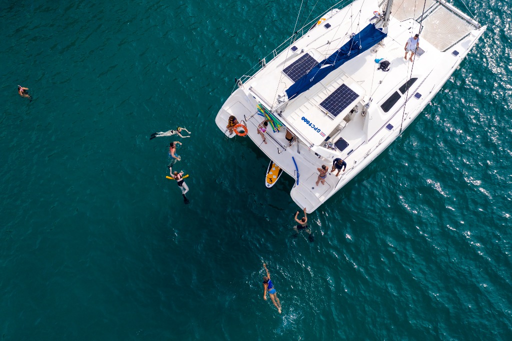 people swimming in water near a boat