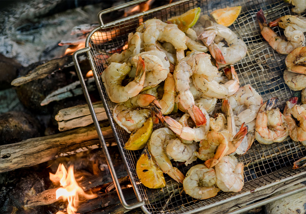 shrimp being cooked over a fire
