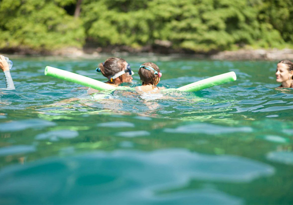 a family swimming in water