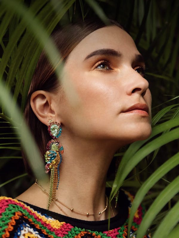 Photo of a woman with green plants around her