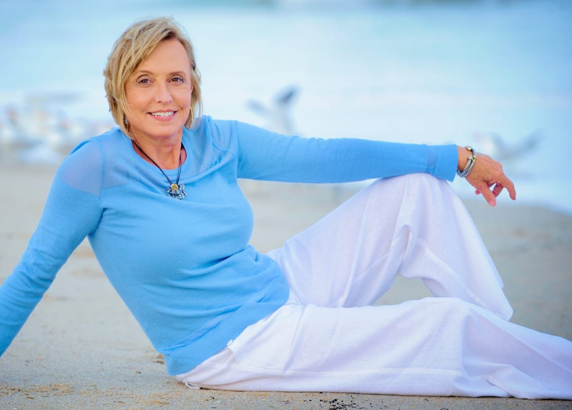 woman in a blue top and white pants