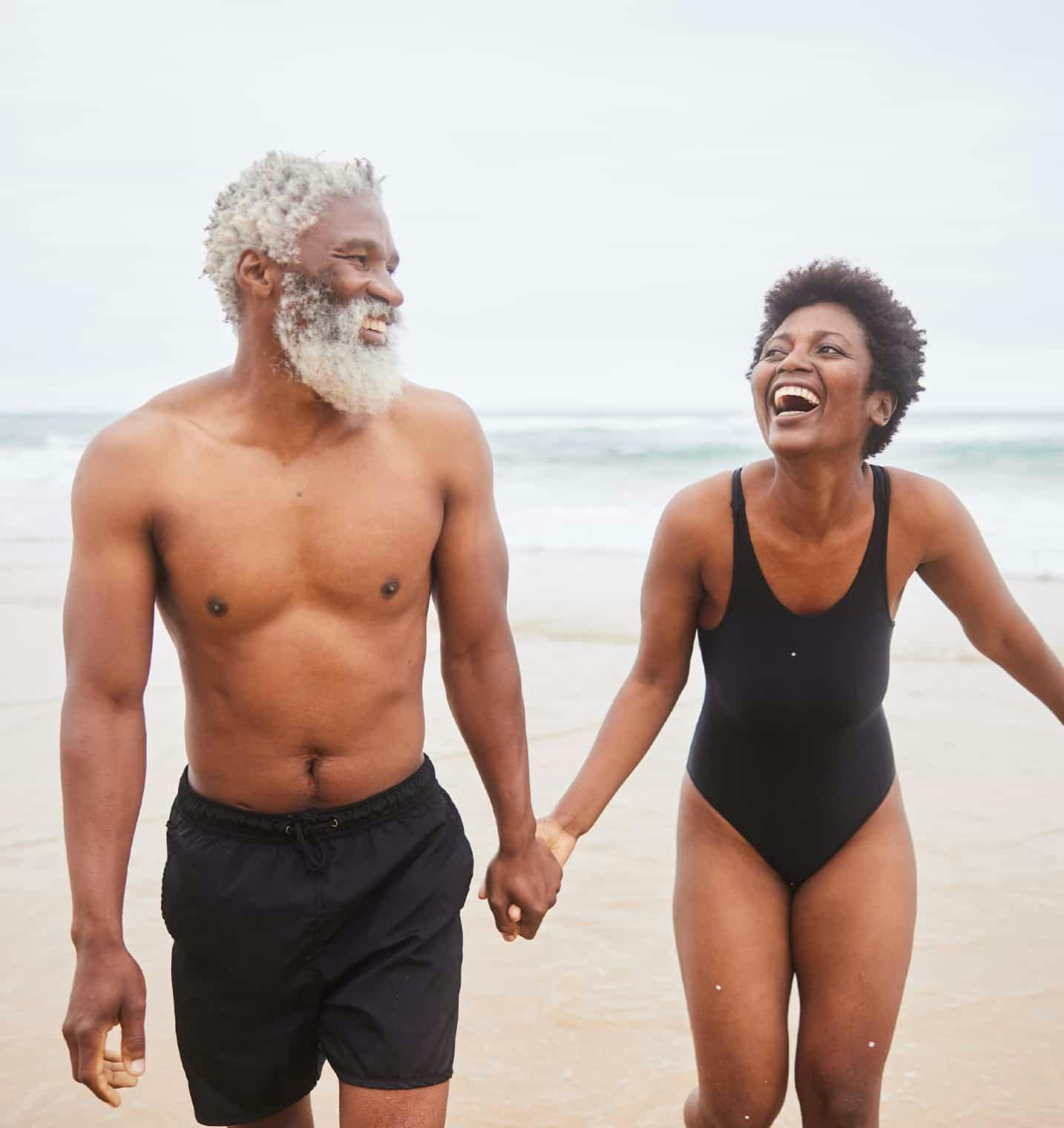 Man and woman laughing on the beach