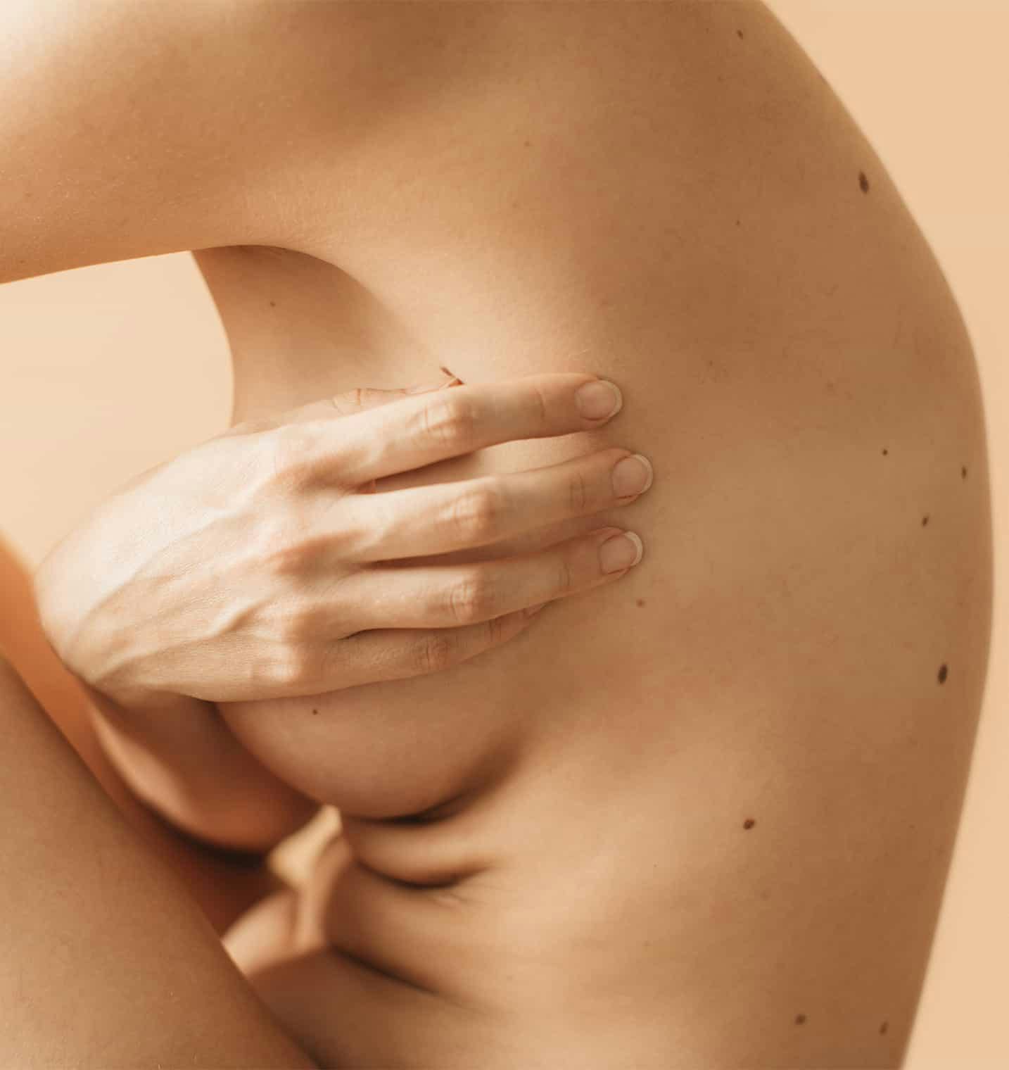 Woman covering breast