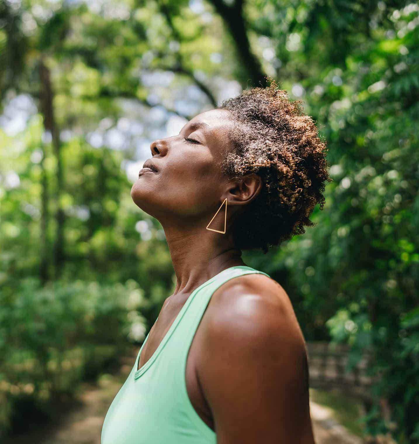 Woman outdoors looking up