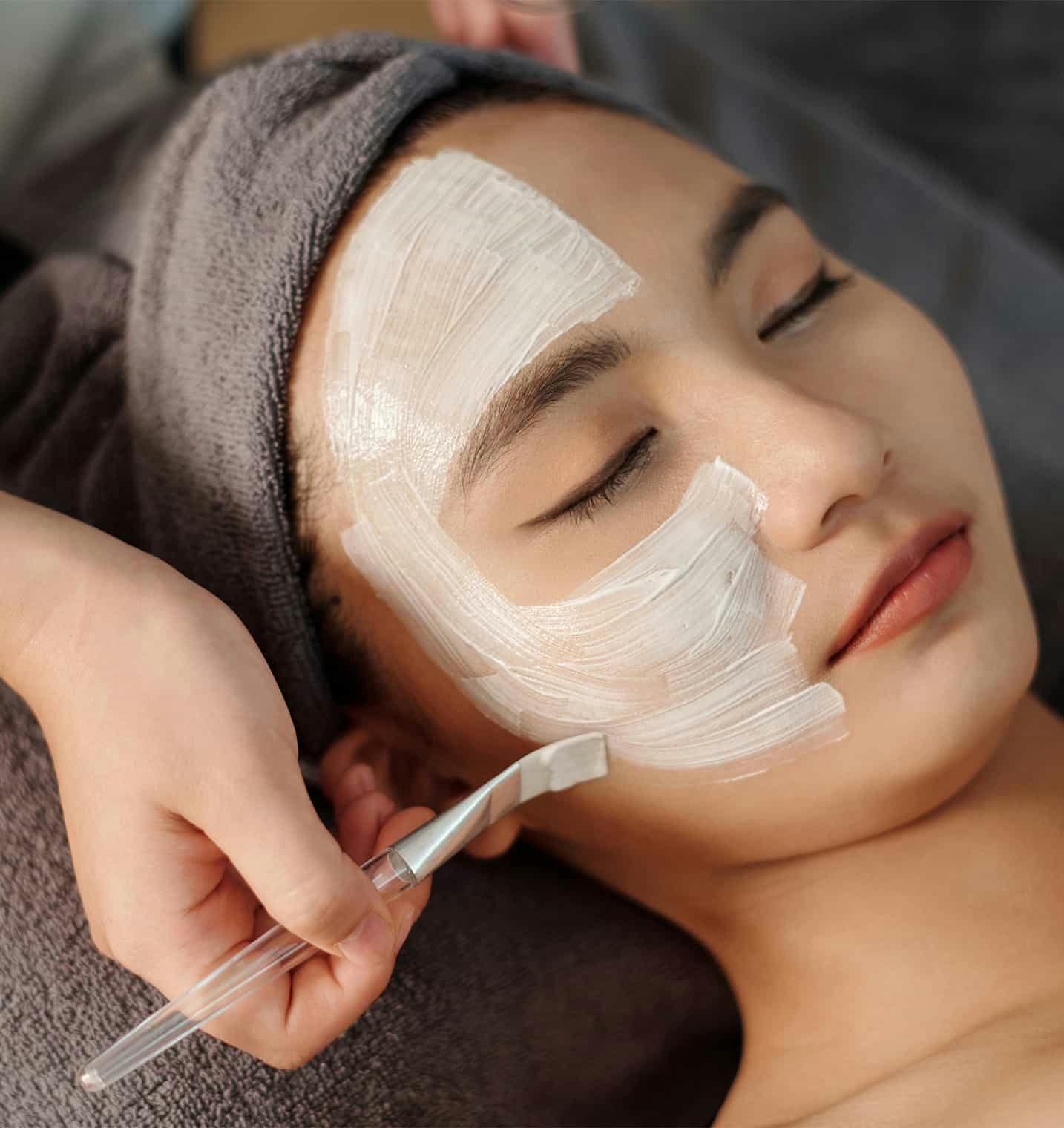 Woman getting facial peel