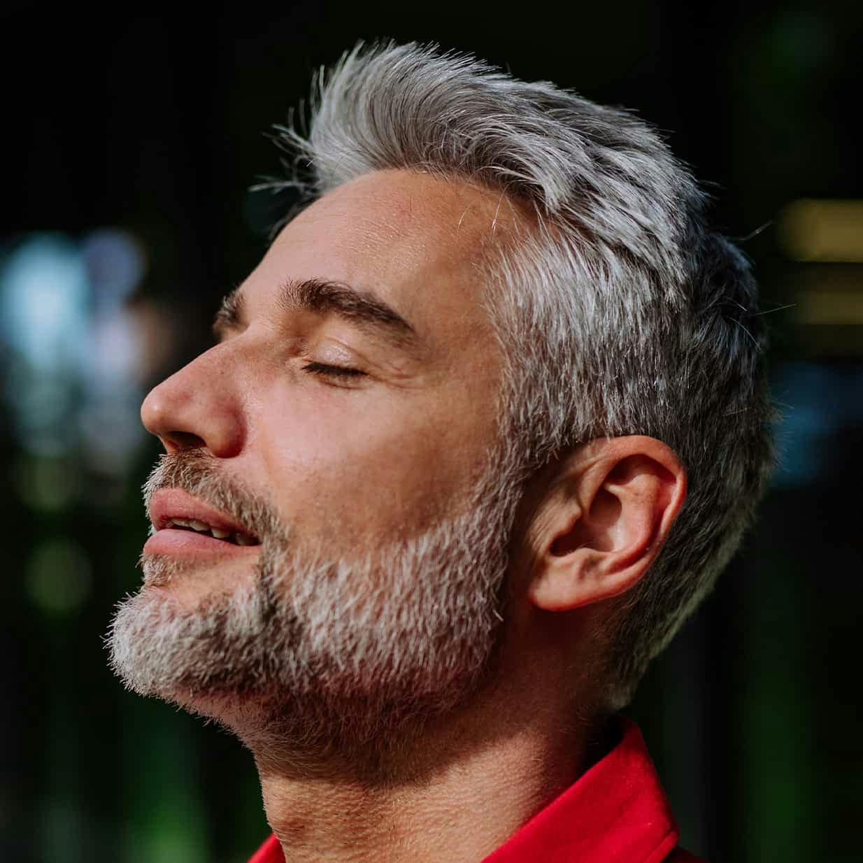 Man with eyes closed smiling