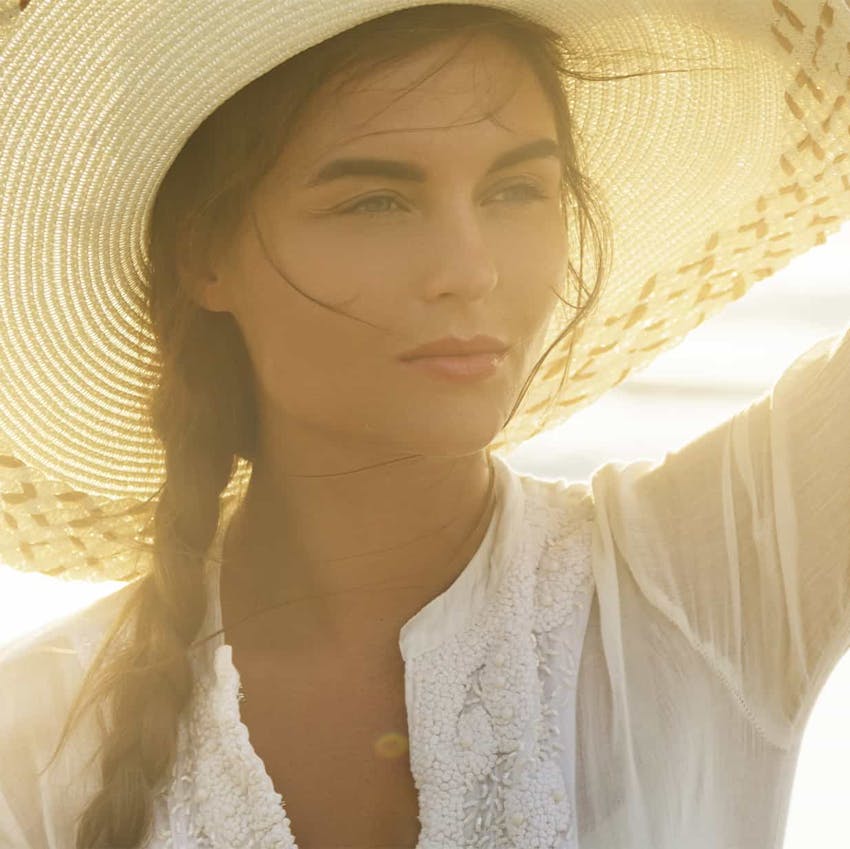 woman in a hat outside