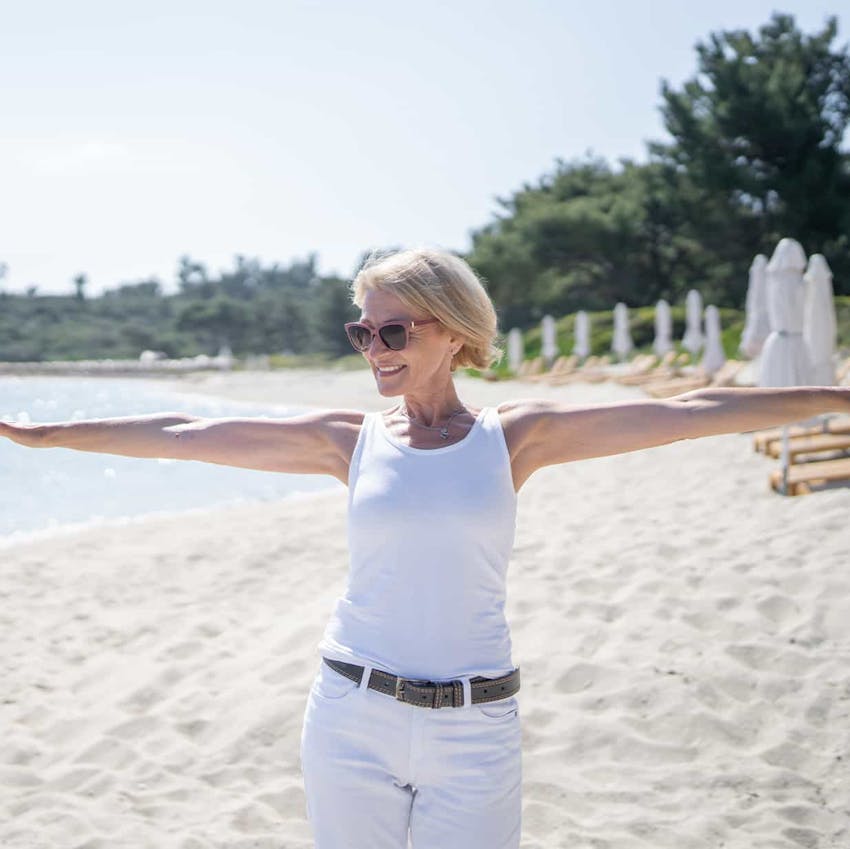 Woman with arms out on the beach