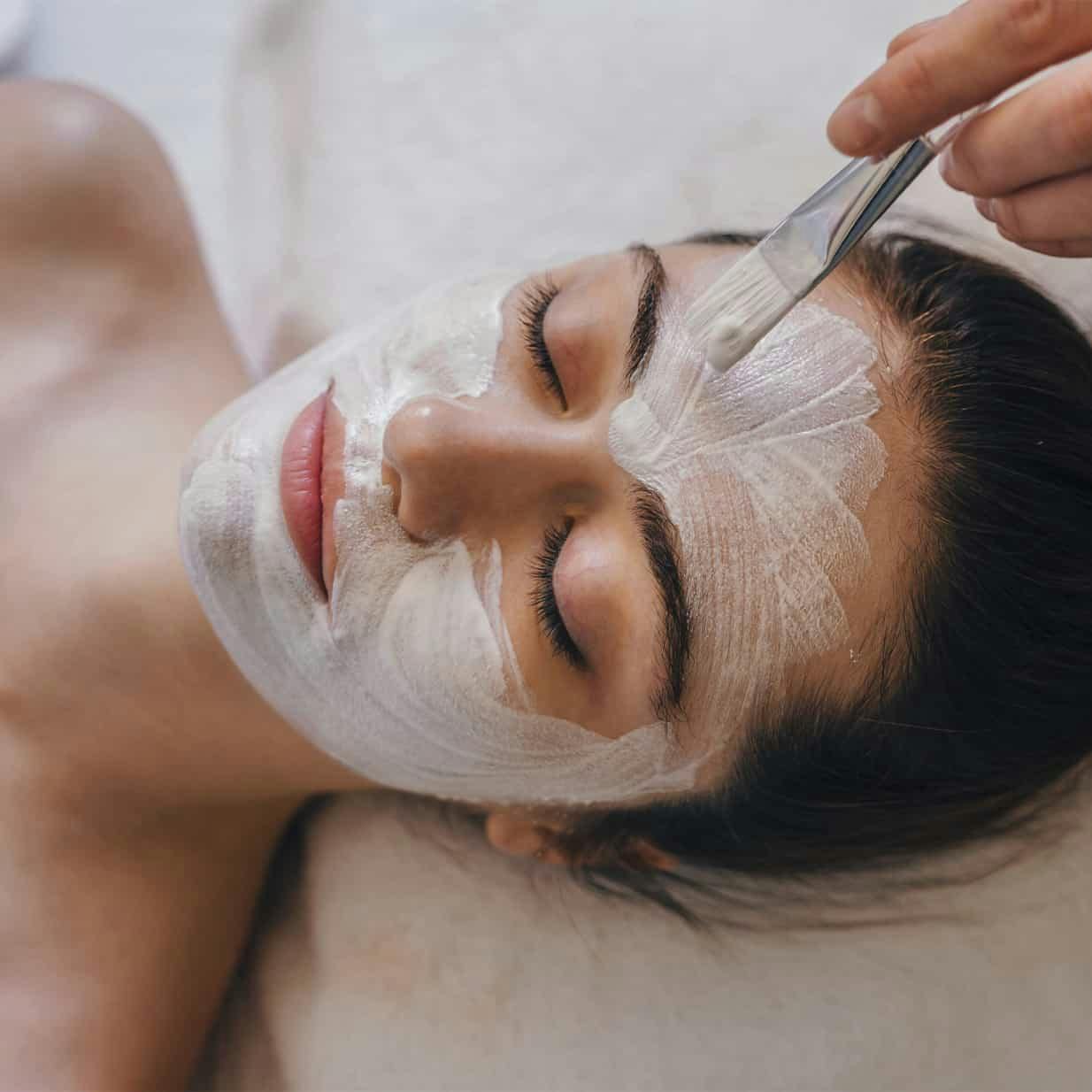 Woman receiving a facial peel