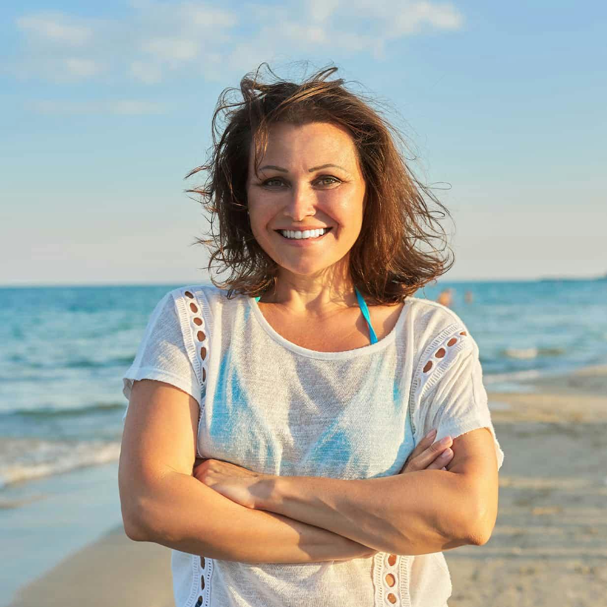 Woman on the beach smiling