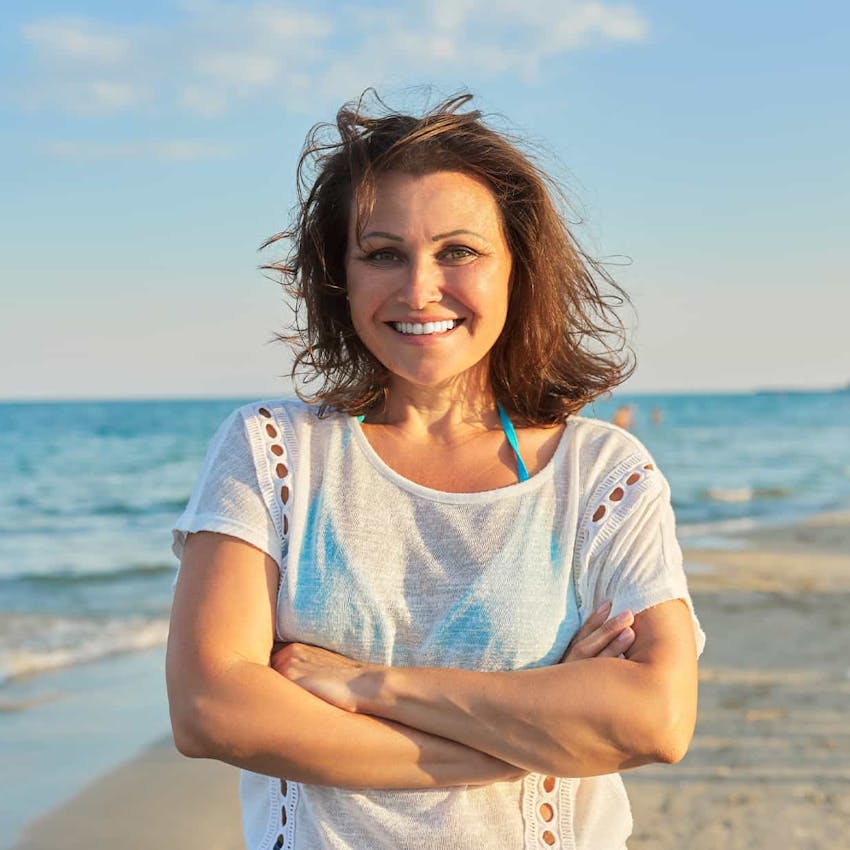 Woman on the beach smiling