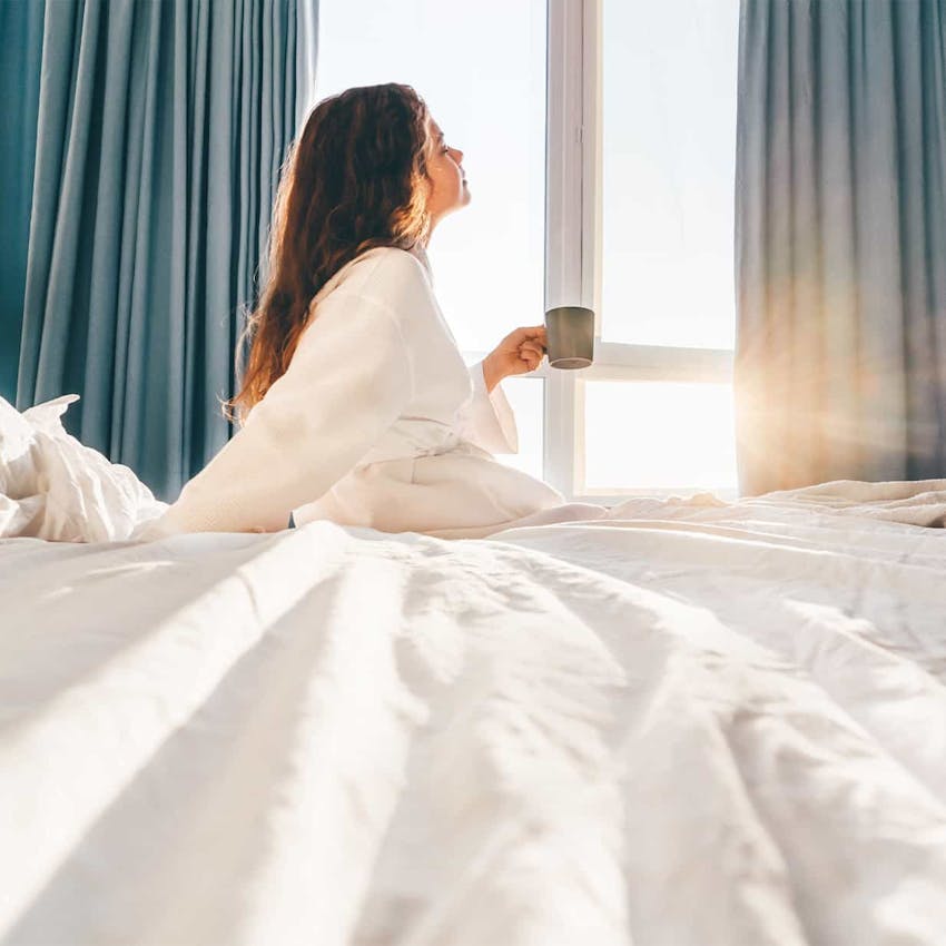 Woman sitting on a bed