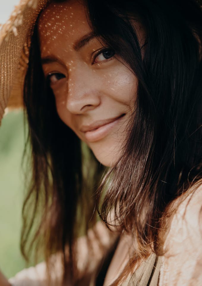 Woman in a hat, smiling