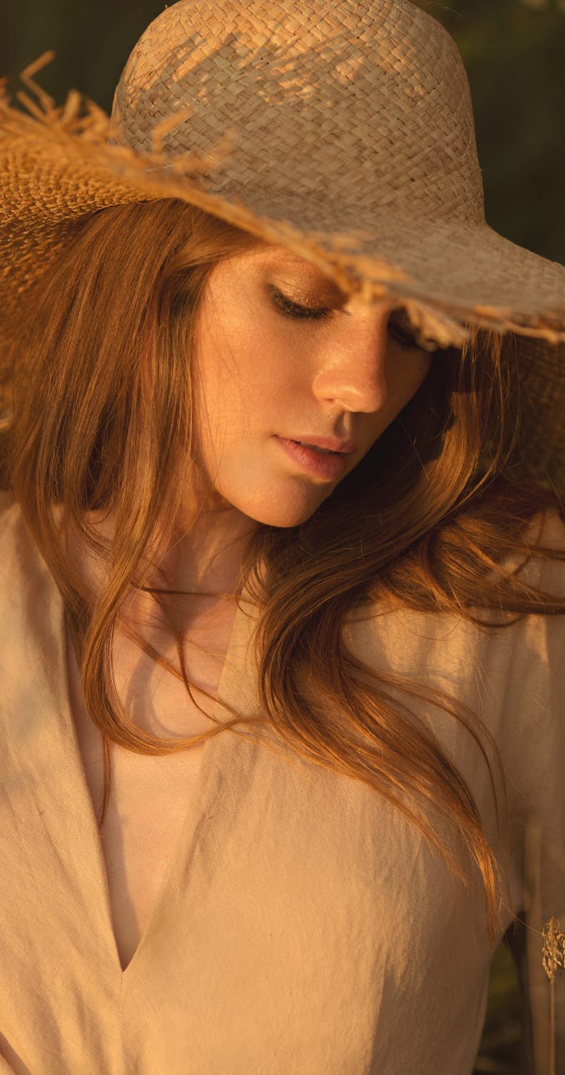 Woman with a sun hat, looking down