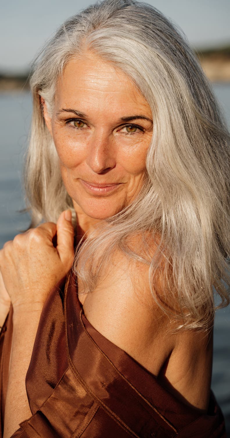 Older woman looking over her shoulder and smiling