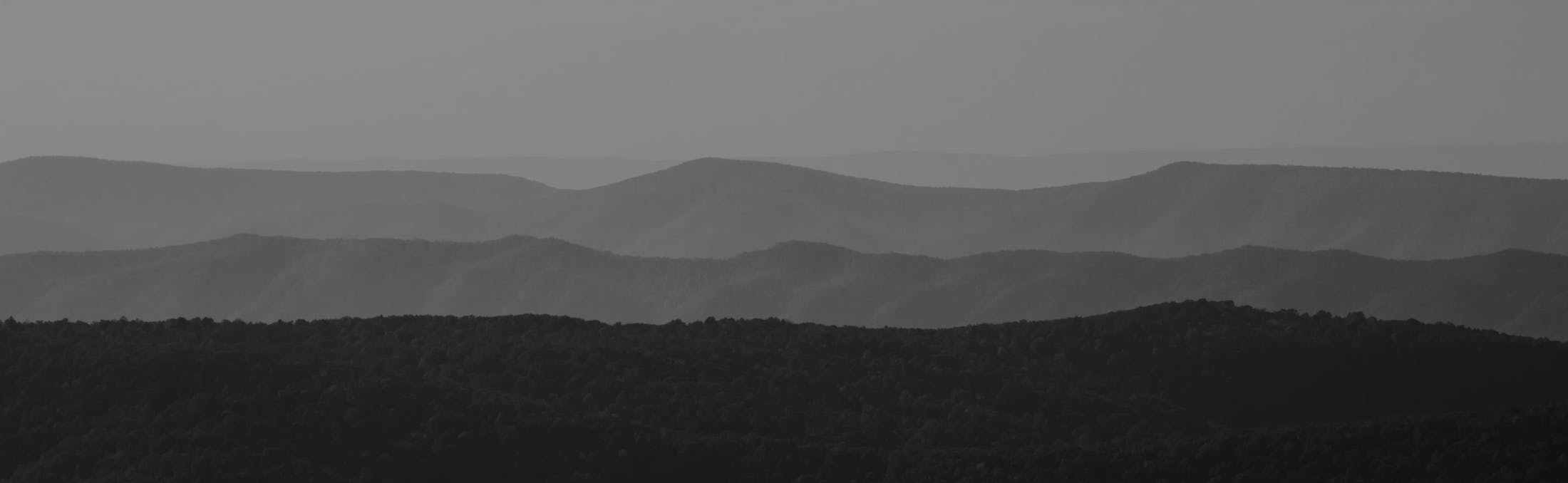 Black and white photo of mountains on the horizon