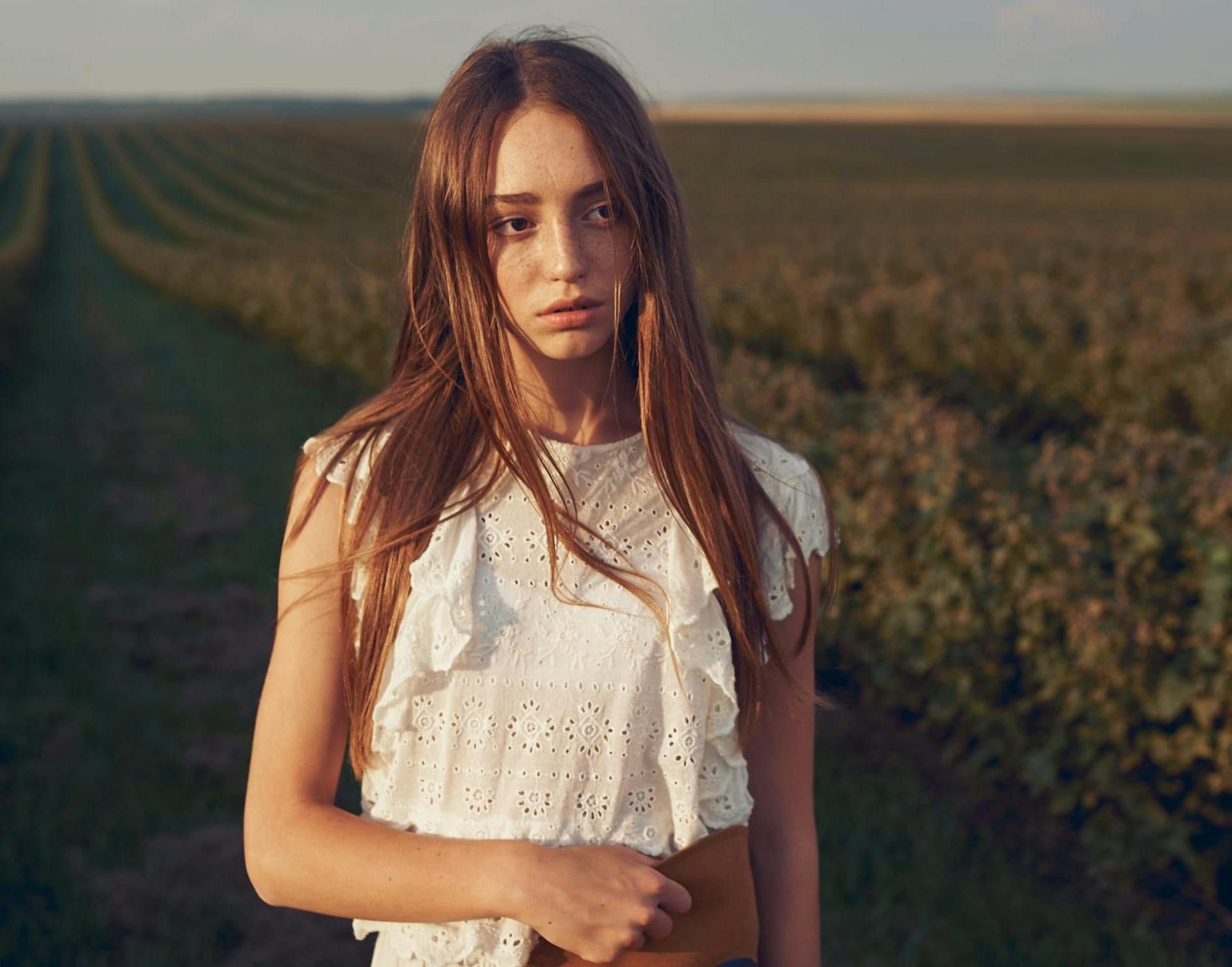 Woman standing in a field of crops