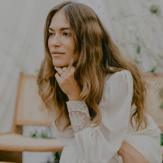 Woman with a hand to her chin