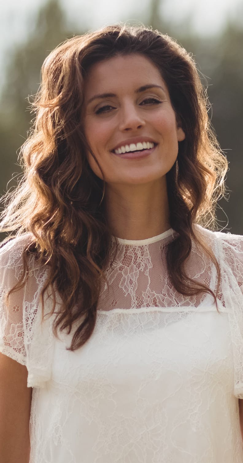Woman with brown hair and a white top