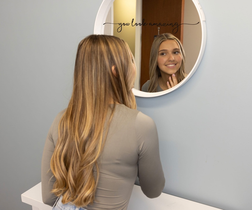 woman looking at herself in a mirror