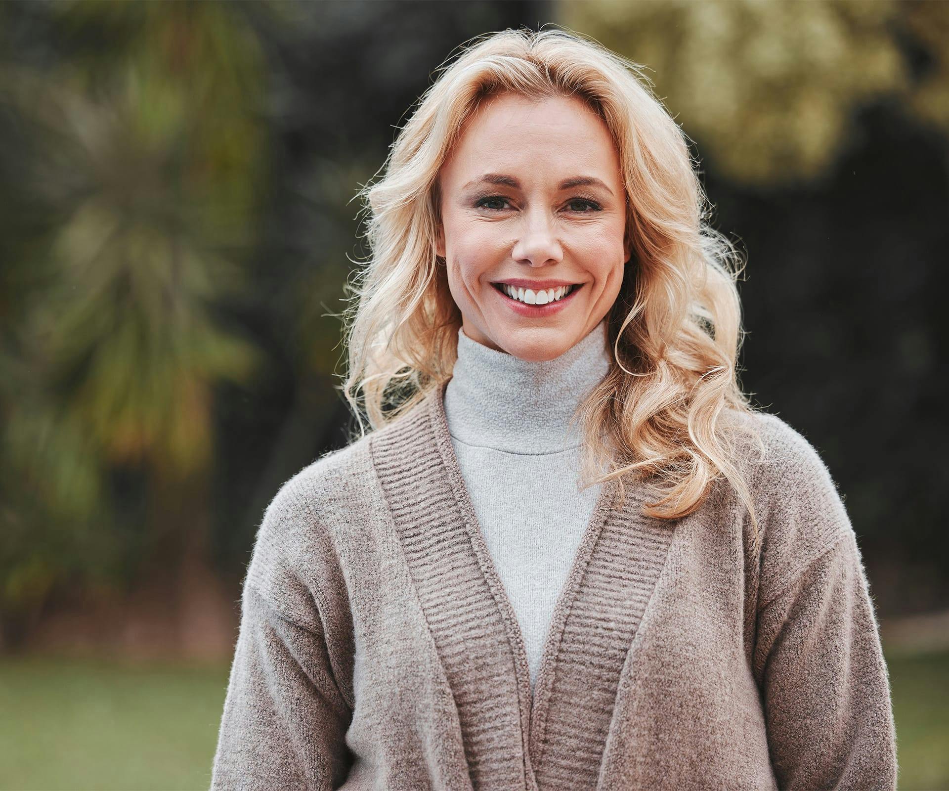 Smiling woman in turtleneck sweater