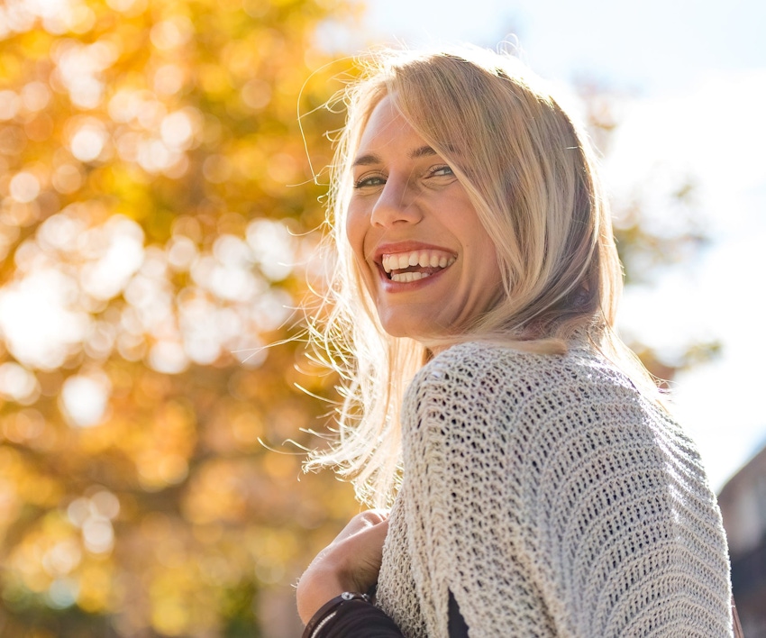 woman with blonde hair outside smiling