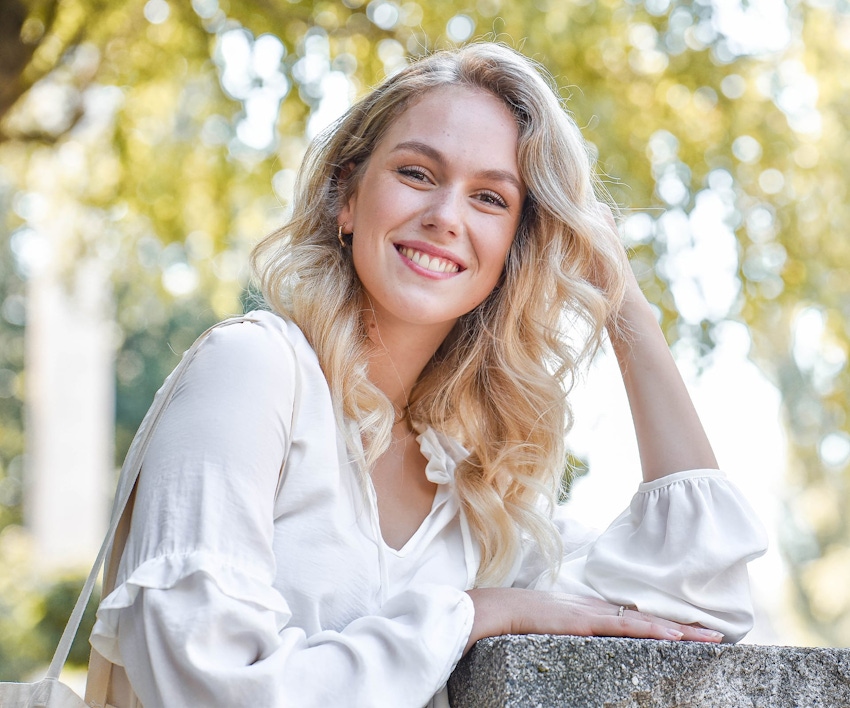 Woman with wavy blonde hair smiling