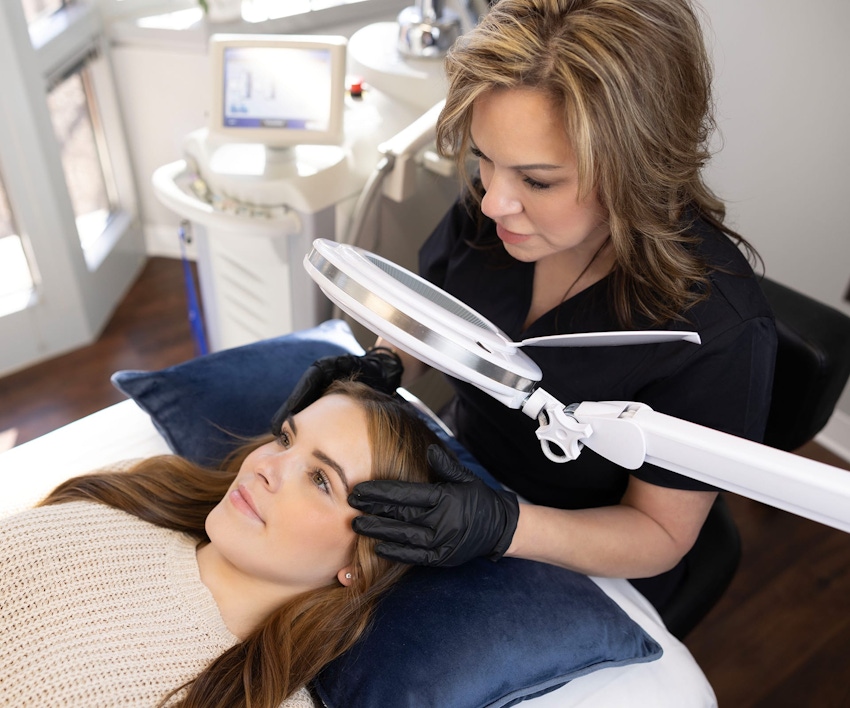 Woman receiving skin care consultation