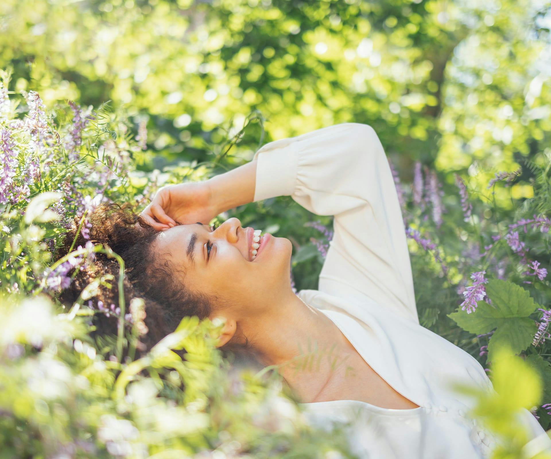 woman laying in flowery field