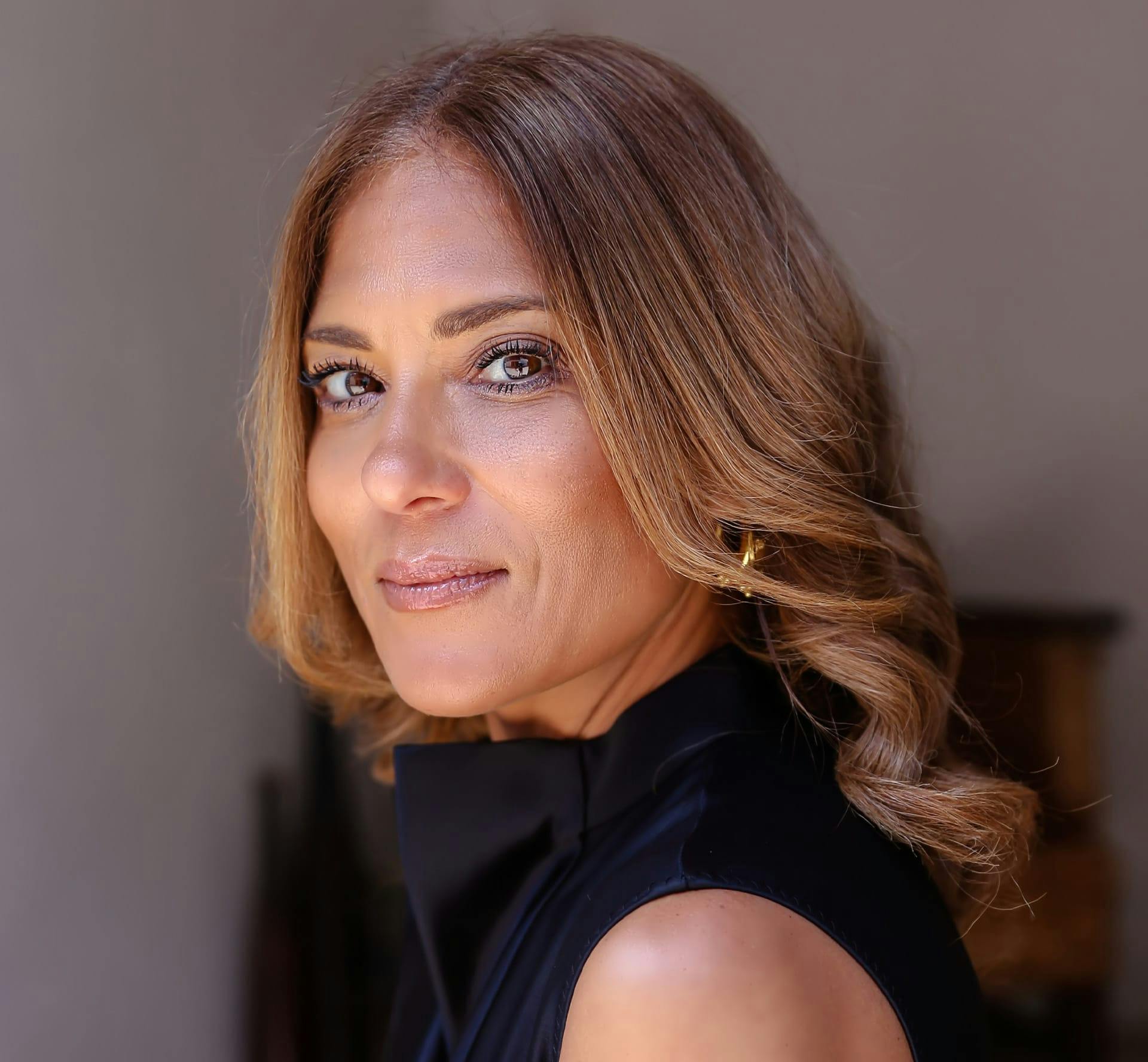 Woman smiling over shoulder