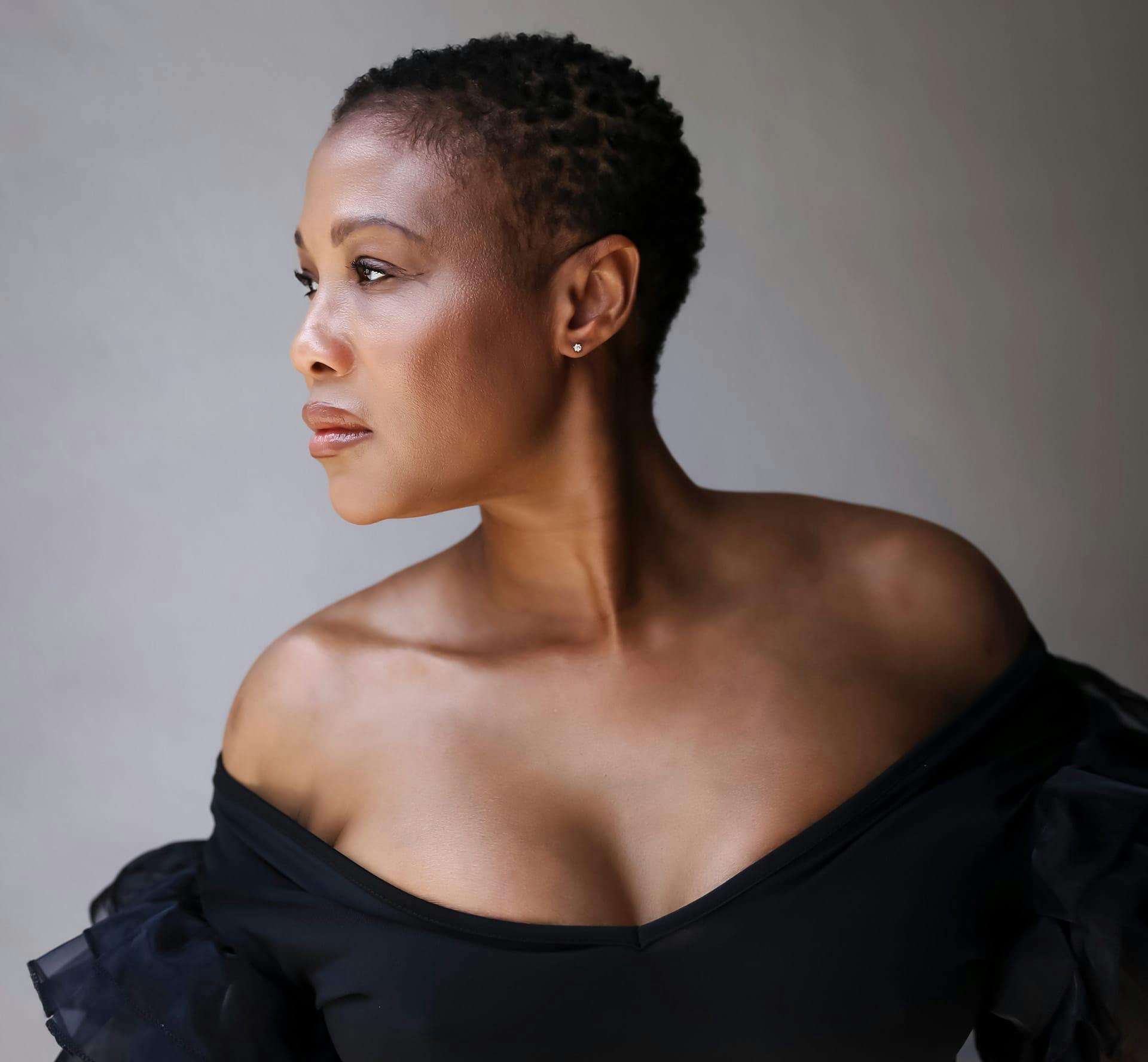 Woman with short hair looking over shoulder