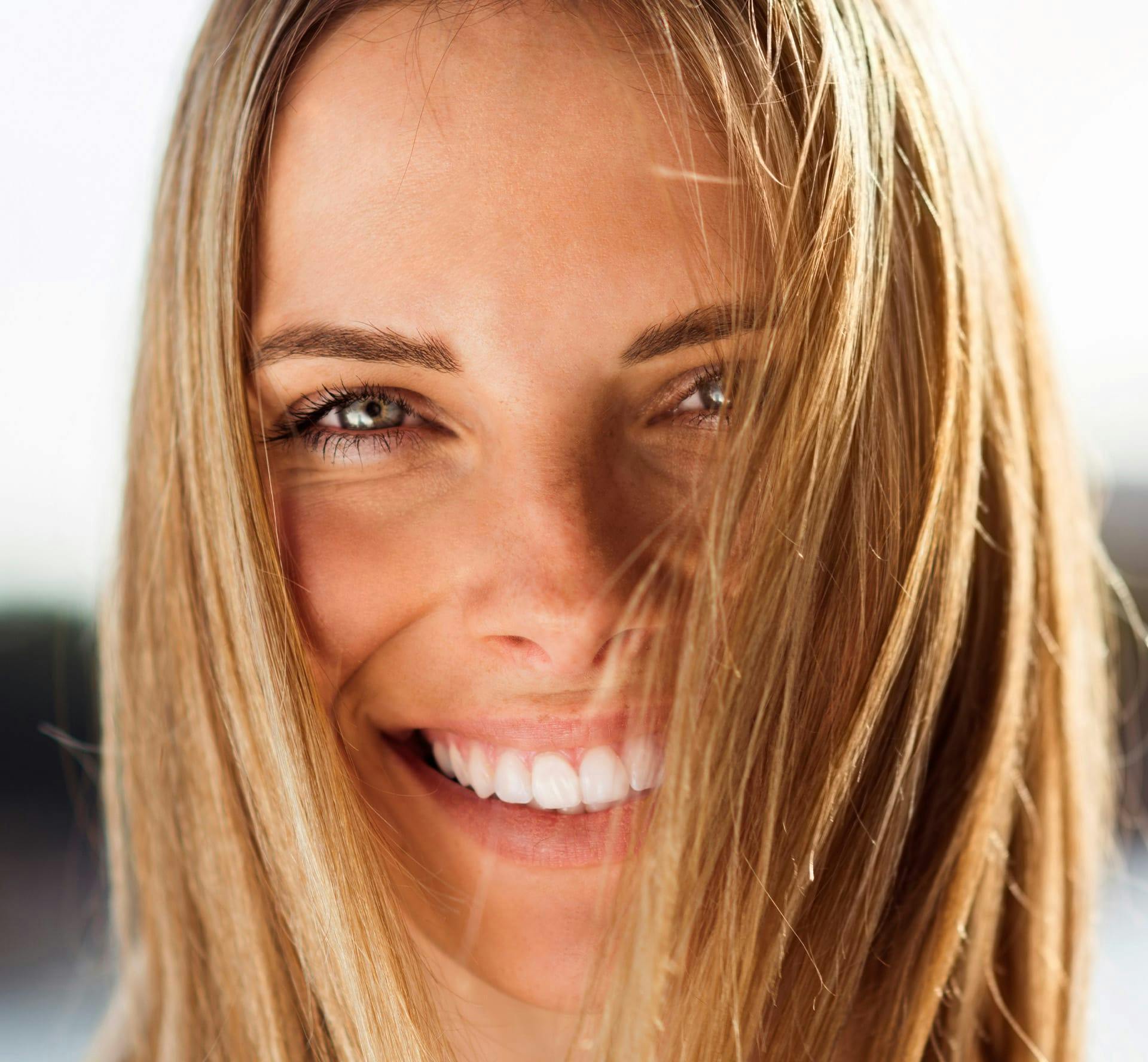Woman smiling with hair in her face