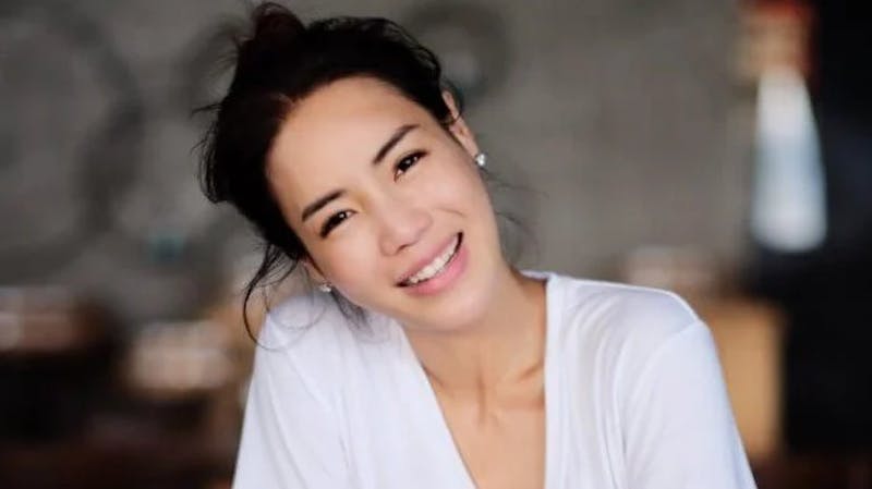 woman wearing a white shirt, smiling
