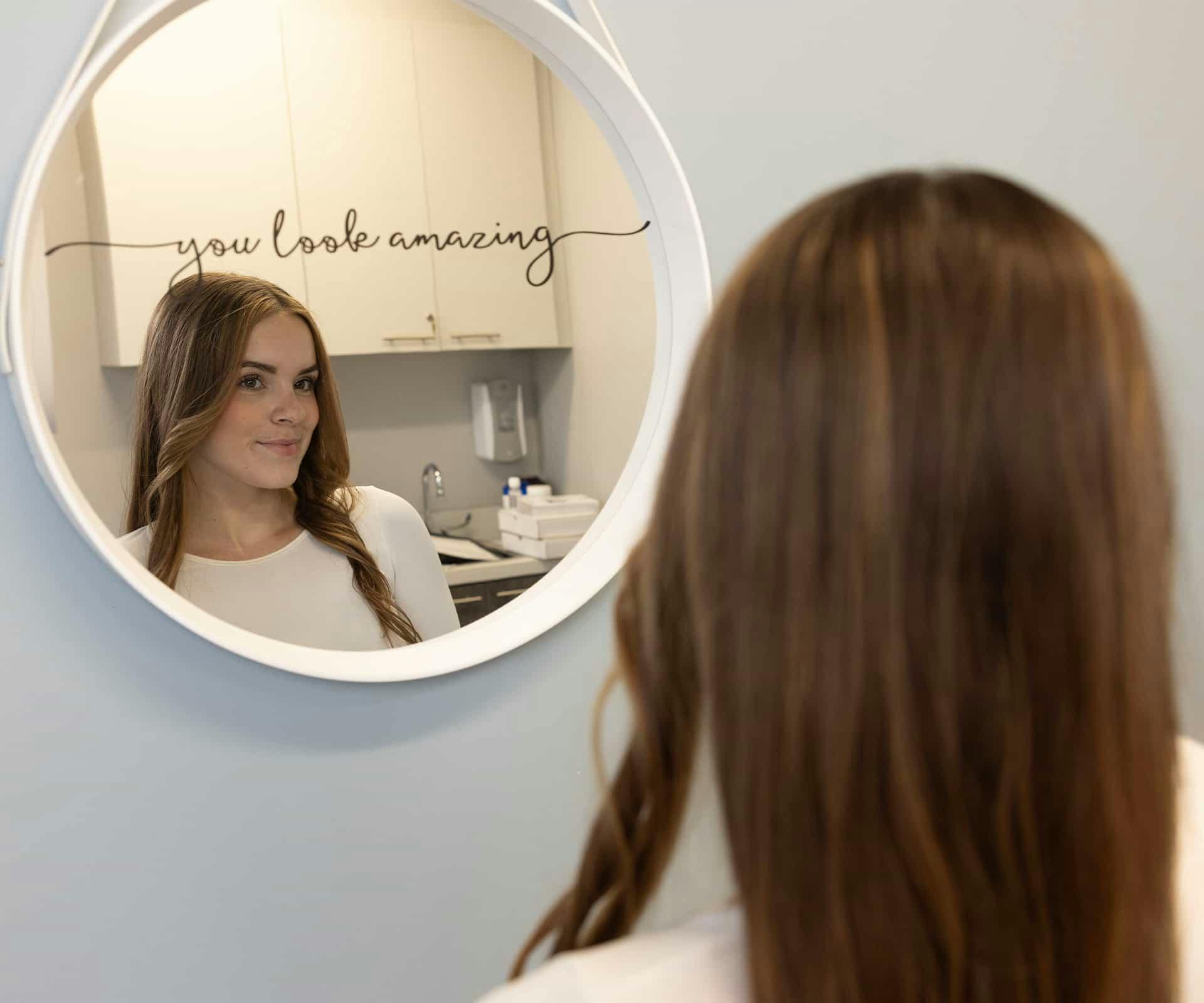 Woman looking on mirror smiling