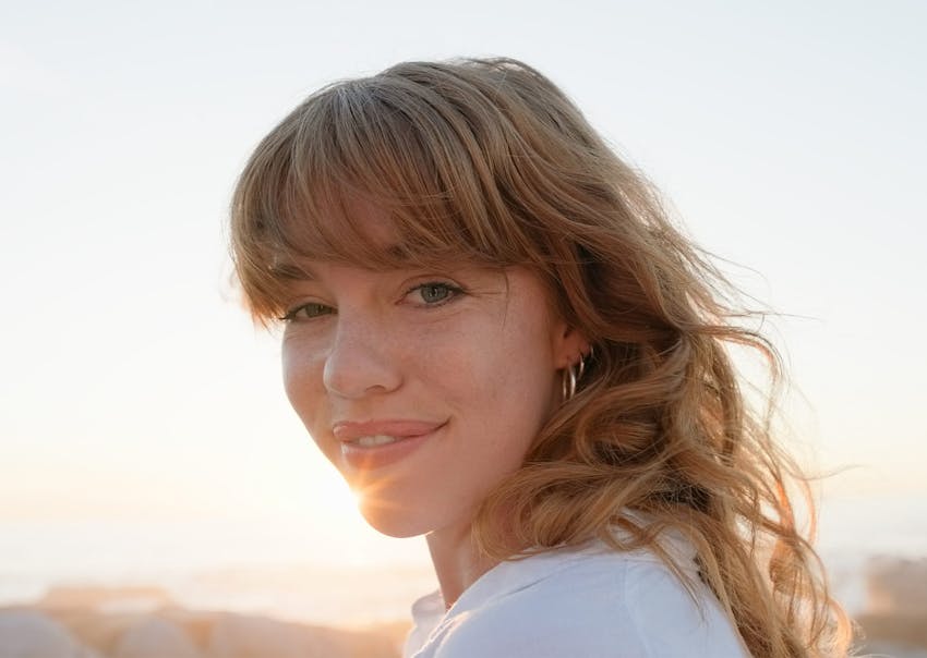 Brunette woman standing in the sun