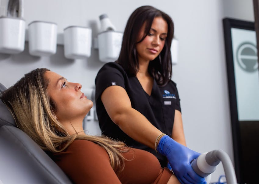woman getting an emsculpt treatment