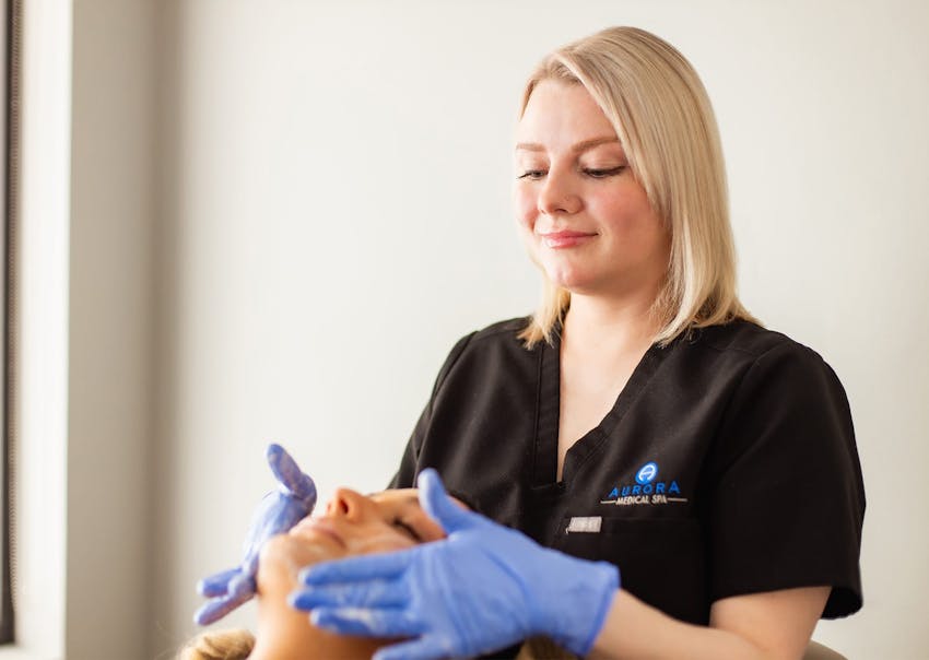 Aurora practitioner administering facial peel