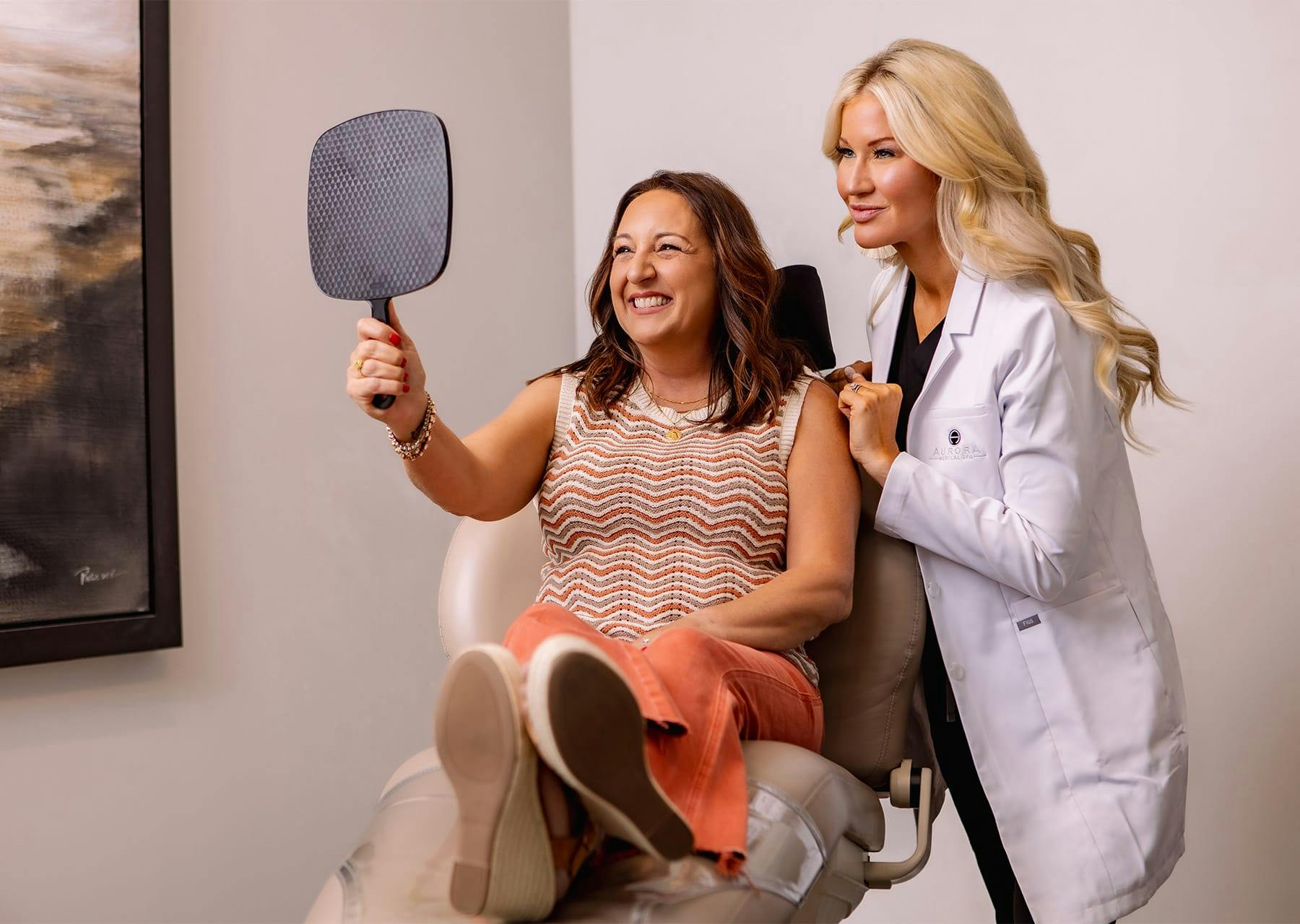 patient smiling while looking at herself in a mirror