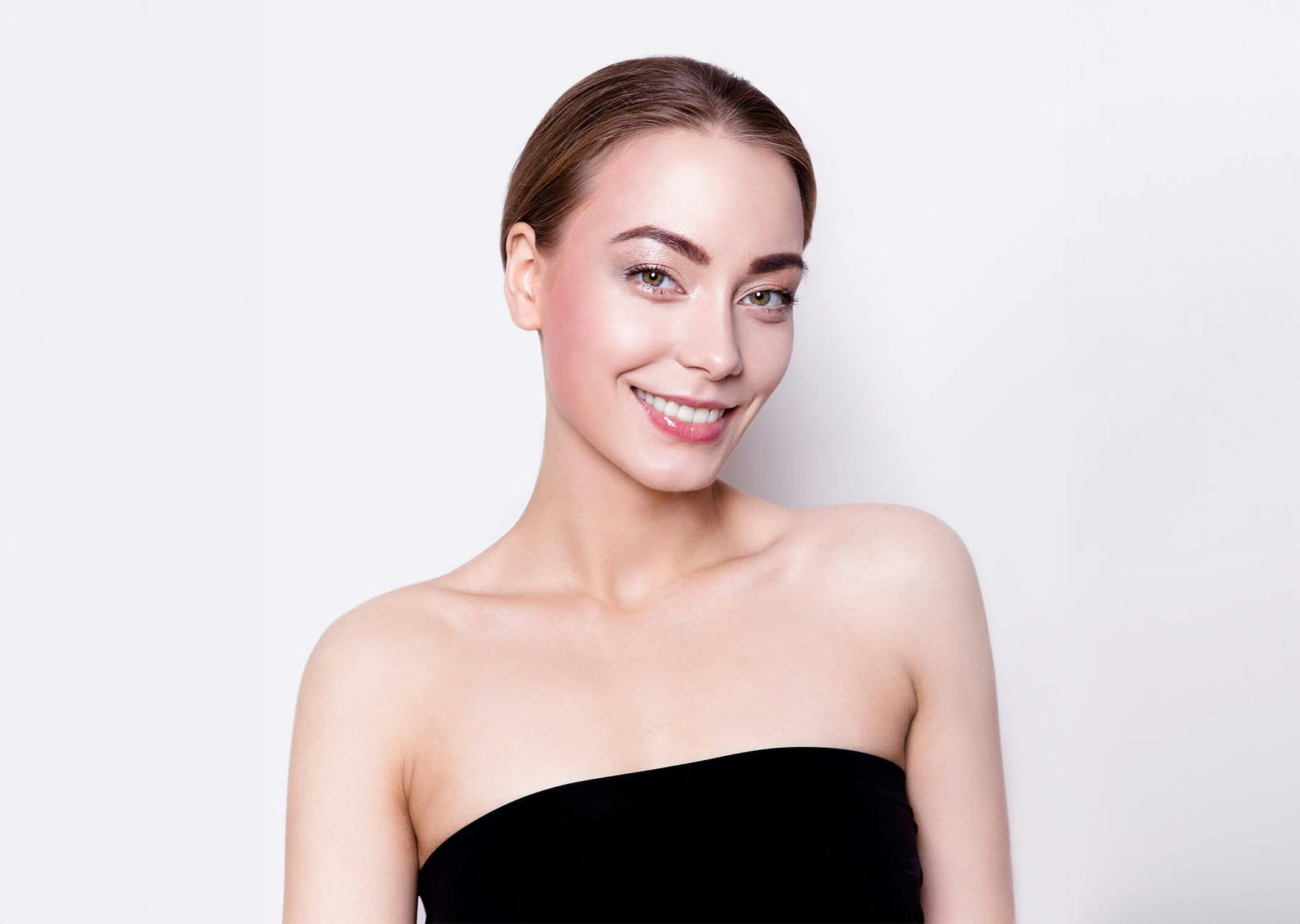 woman with her hair pulled back wearing a strapless black top