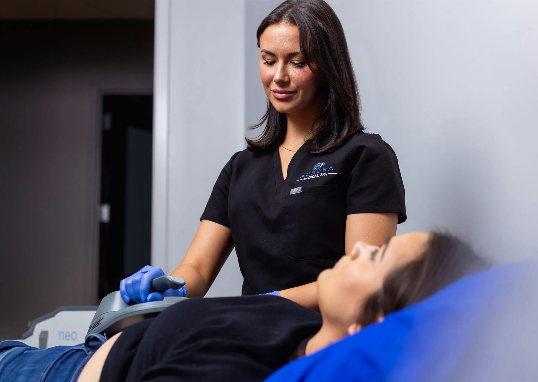 Aurora MedSpa practitioner administering Emsculpt