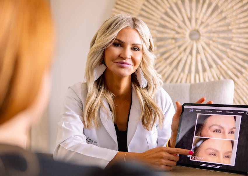 provider at Aurora Medical Spa showing a patient their results on an ipad