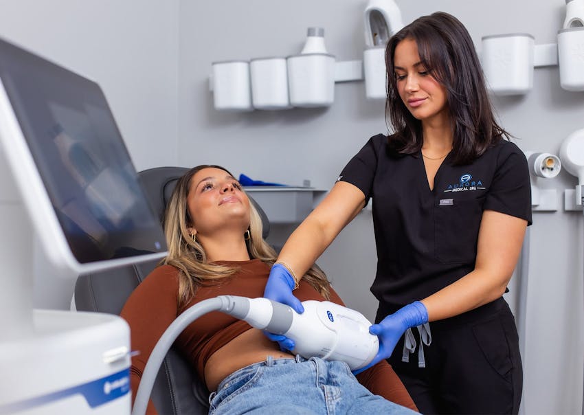 Woman receiving EmSculpt Neo