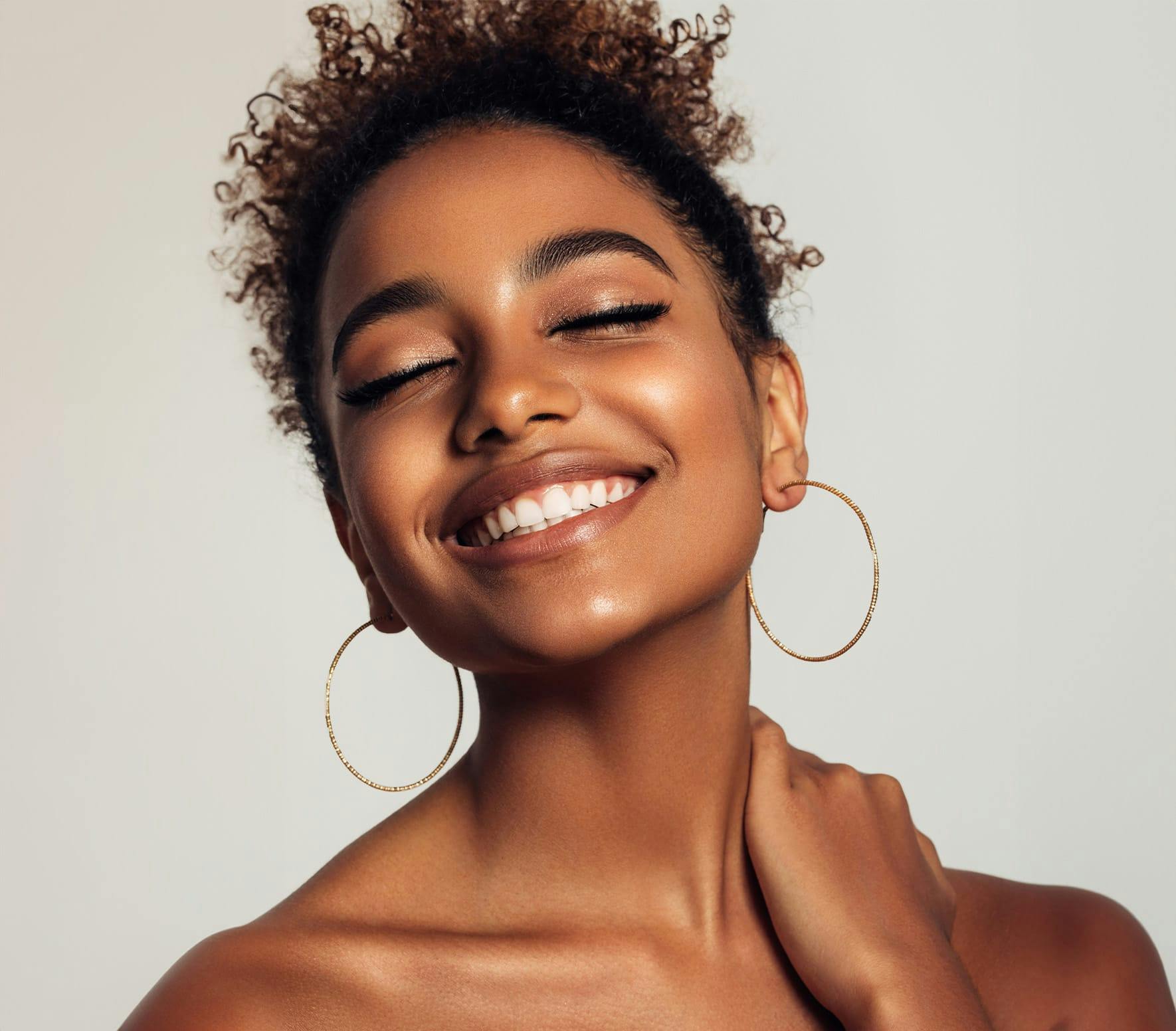 woman smiling with her eyes closed