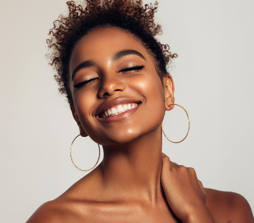 woman smiling with her eyes closed