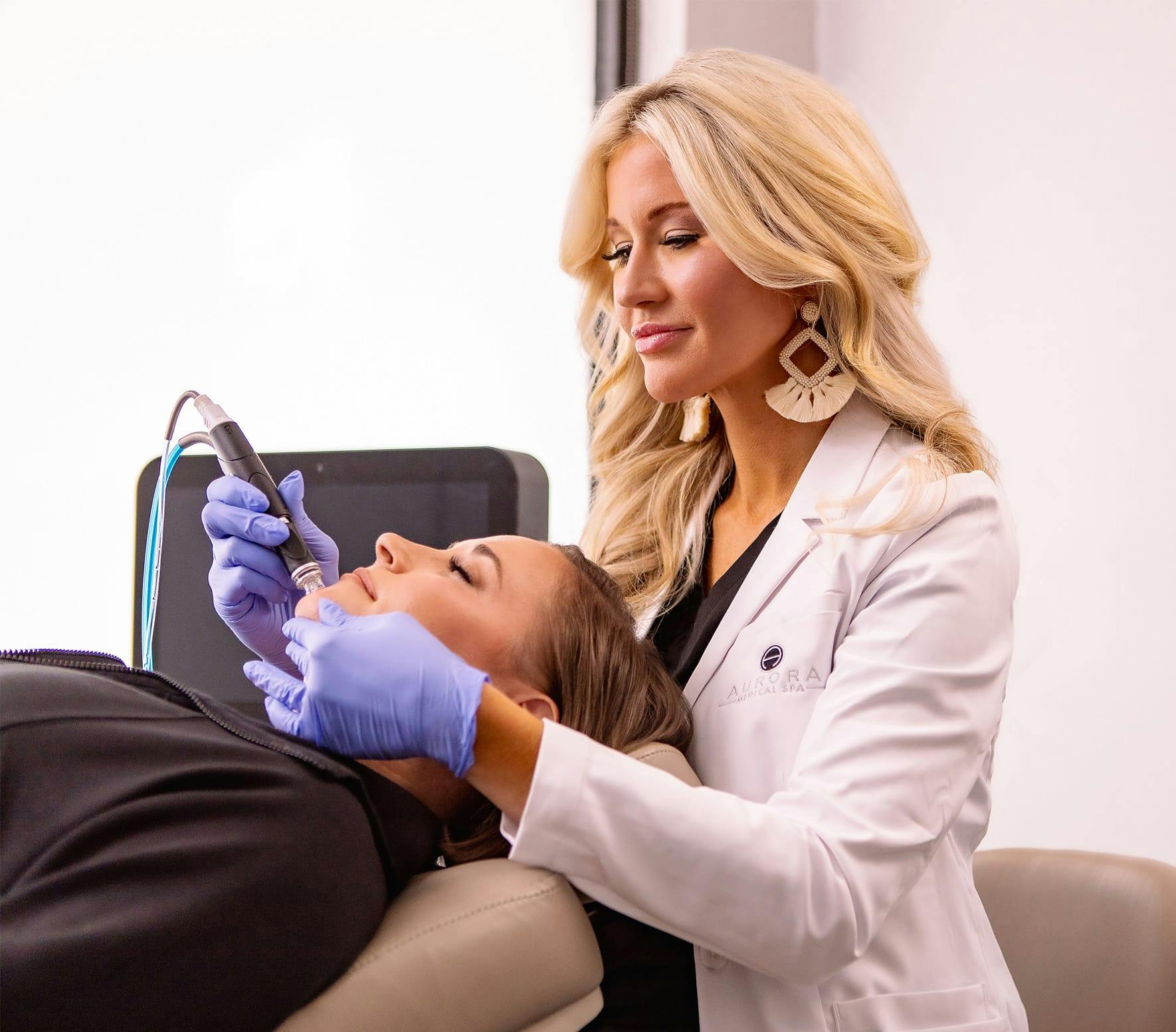 Kandice administering facial treatment