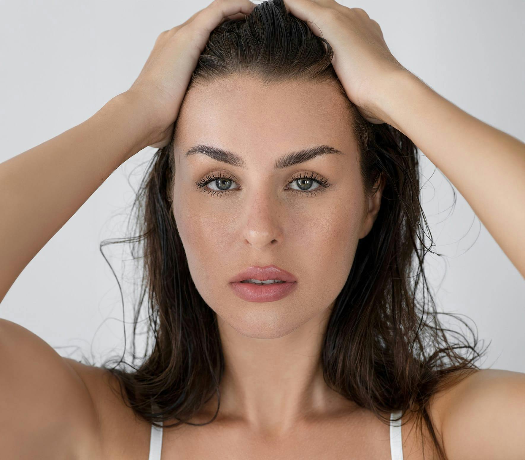Woman running hands through hair