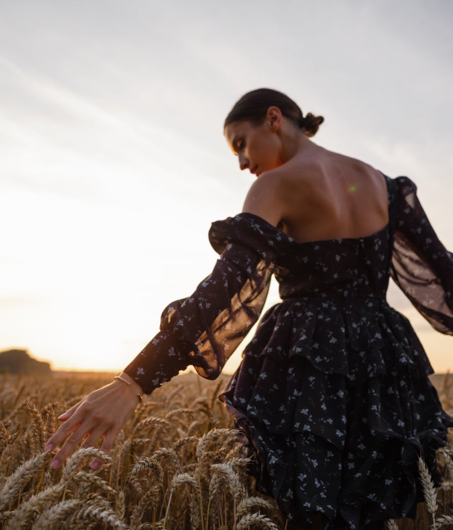 Woman walking through tall grass